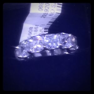 14k white gold round cut eternity band. Niemans